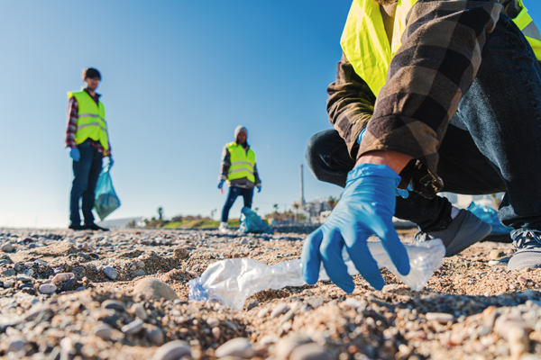 volunteer-man-s-hand-with-gloves-picking-up-plasti-2023-03-17-17-49-56-utc.jpg